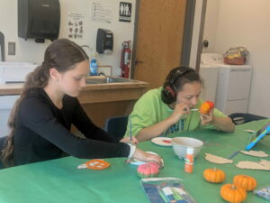 Two Unified Art students working on a yarn project